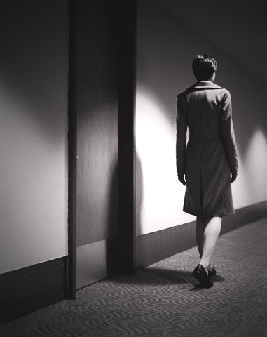 Woman Walking Down a Hallway